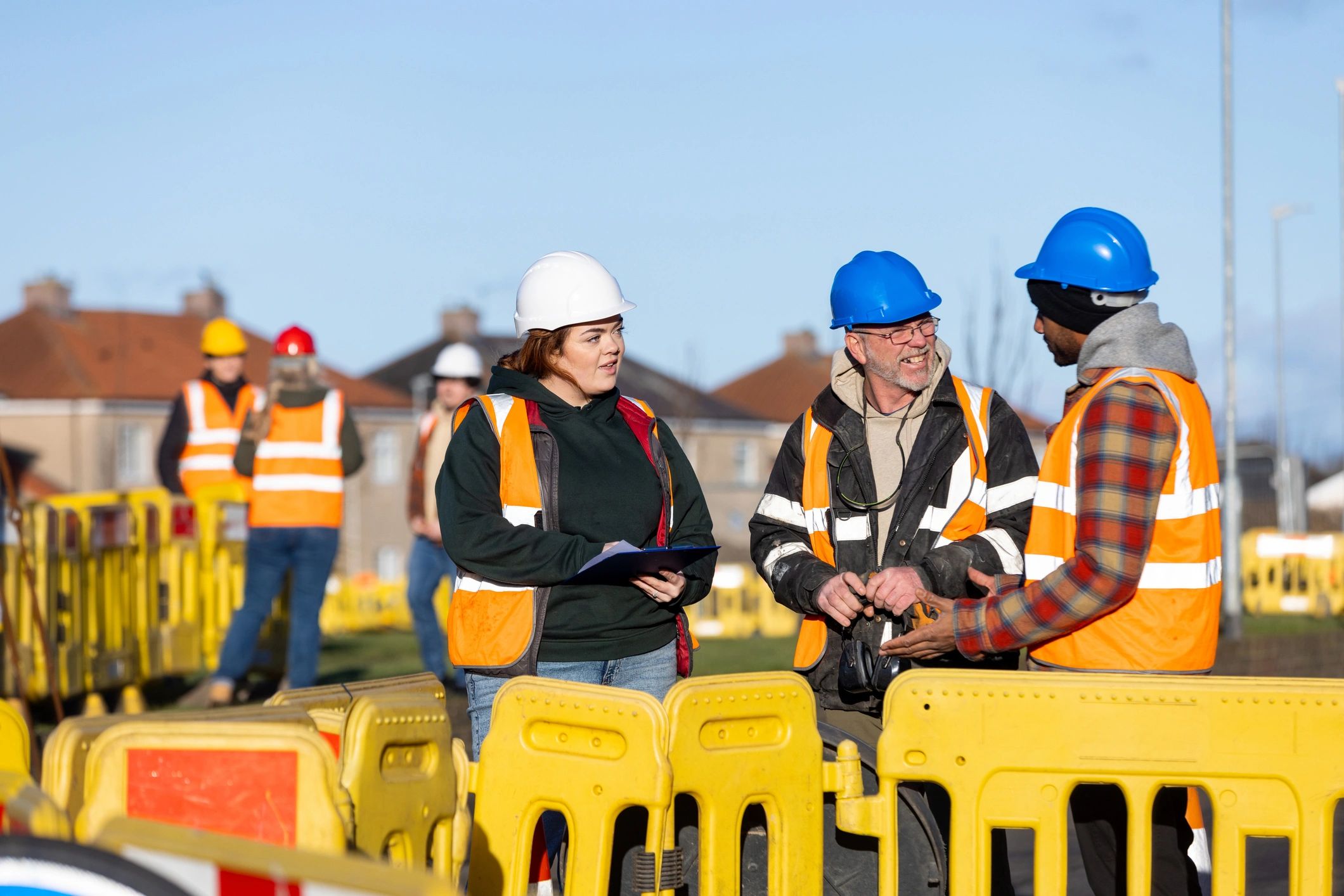 Engineers and builders discussing work plans at a construction site