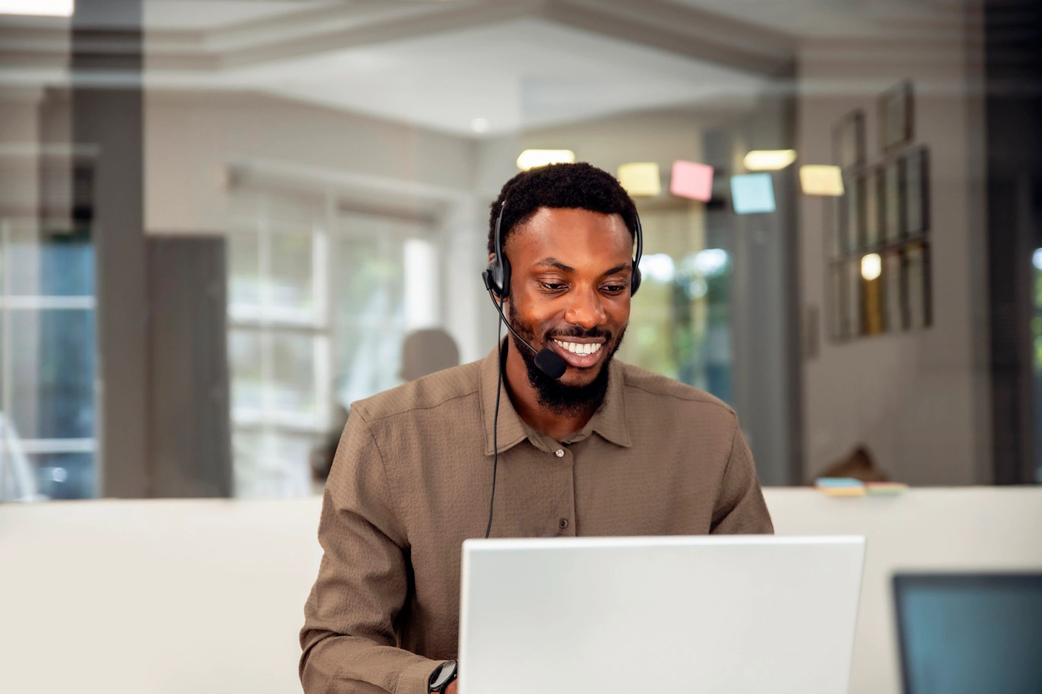 Professional customer support specialist using a laptop